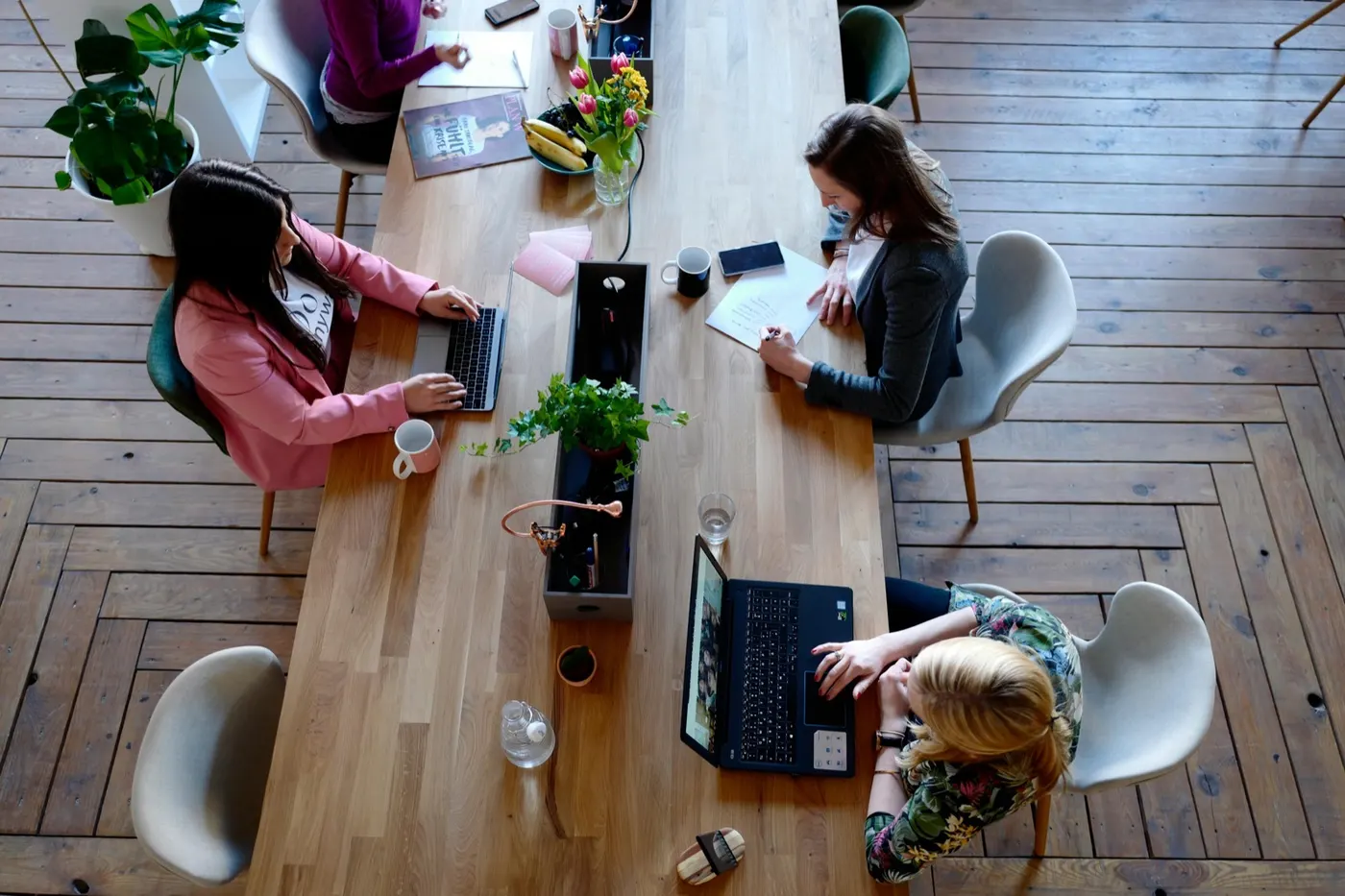 Colleagues collaborating over a laptop